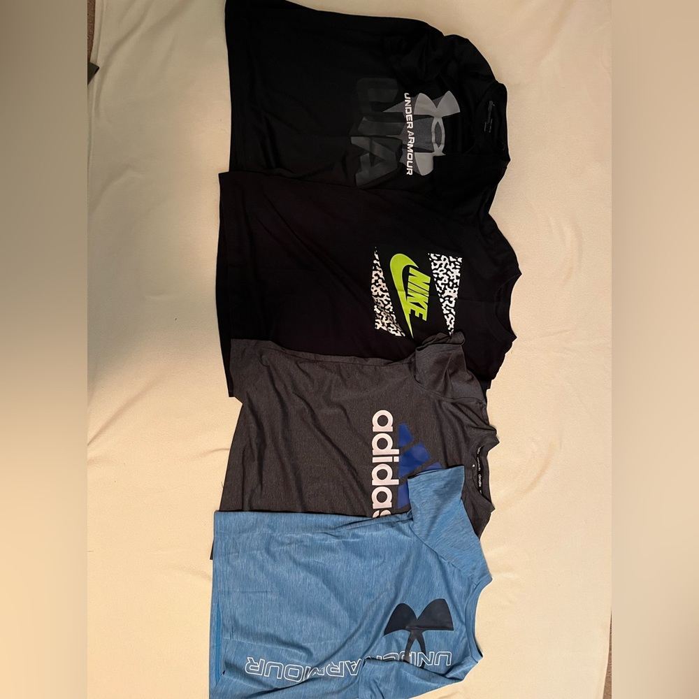 Four shirts one Nike one adidas and two under armor GREAT CONDITION size medium